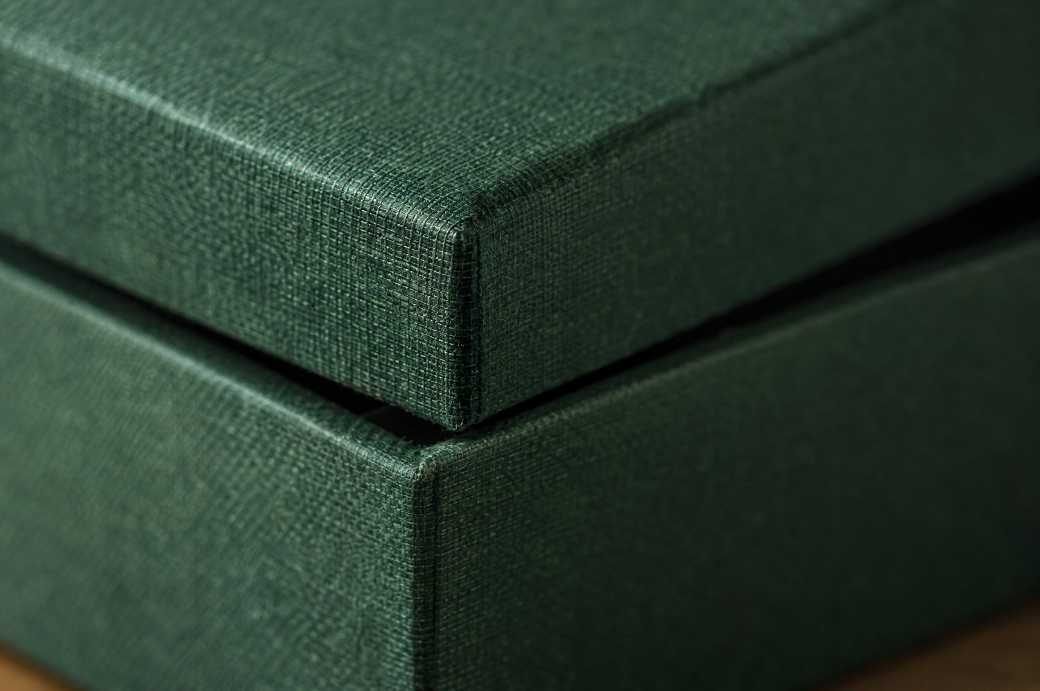 Macro view of the wrapped corner of a green rigid box